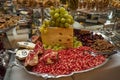 Cheese, fruits, green grapes, nuts, cherries, bread, luxury candy bar