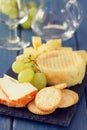 Cheese with grapes and cookies and glass