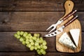 Cheese, grapes, knife and fork