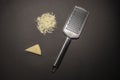 Cheese grater a piece of cheese, and a heap of grated cheese