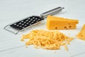 Cheese and grater on white background.