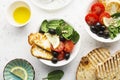 Cheese haloumi brown rice bowl with tomatoes, olives, lemon and pine nuts. Top View Royalty Free Stock Photo