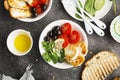 Cheese haloumi brown rice bowl with tomatoes, olives, lemon and pine nuts. Top View