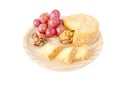 Cheese, hazelnuts, walnut and red grape on the wooden board