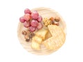 Cheese, hazelnuts, walnut and red grape on the wooden board top