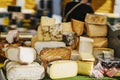 Cheese heads on market counter on market counter. Gastronomic dainty products, real scene, food market Royalty Free Stock Photo