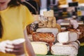 Cheese heads on market counter. Selective focus. Gastronomic dairy produce, real scene, farm food Royalty Free Stock Photo