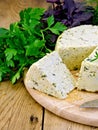 Cheese homemade round with herbs on board Royalty Free Stock Photo