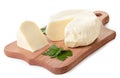 Cheese on a kitchen board with parsley leaves on a white background. Isolated Royalty Free Stock Photo