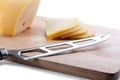 Cheese knife on cutting board Royalty Free Stock Photo