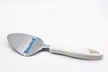 Cheese knife with plastic handle on white Royalty Free Stock Photo