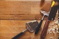 Cheese knives on rustic wood background, copy space