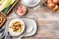 Cheese leek soup with croutons and bacon in a bowl on a wooden table Royalty Free Stock Photo