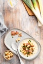 Cheese leek soup with croutons and bacon in a bowl on a wooden table Royalty Free Stock Photo