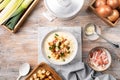 Cheese leek soup with croutons and bacon in a bowl on a wooden table. Royalty Free Stock Photo