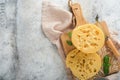 Cheese Maasdam or Radamer. Piece of cheese on wooden standa on old grey concrete background. Top view. Free space for your text