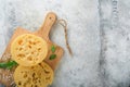 Cheese Maasdam or Radamer. Piece of cheese on wooden standa on old grey concrete background. Top view. Free space for your text