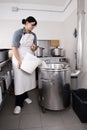 Cheese Maker pours milk into a steel container