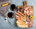 Cheese and meat appetizer selection or wine snack set. Variety of cheese, salami, prosciutto, bread sticks, baguette Royalty Free Stock Photo