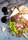 Cheese and meat appetizer selection or wine snack set. Variety of cheese, salami, prosciutto, bread sticks, baguette Royalty Free Stock Photo