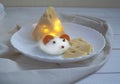 Cheese mouse for New Year`s holiday table with a large piece of Maasdam cheese