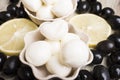 Cheese mozzarella close-up against the background of lemon slices and black olives Royalty Free Stock Photo