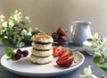 cheese pancakes or curd pancakes with strawberries and cherries Royalty Free Stock Photo