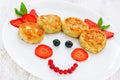 Cheese pancakes with fresh summer berries for child breakfast