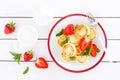 Cheese pancakes, fritters or syrniki with fresh strawberry and yogurt. Healthy and tasty breakfast Royalty Free Stock Photo