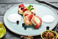 Cheese pancakes with strawberries and sour cream. Breakfast. In the plate. Top view. Flat lay composition Royalty Free Stock Photo