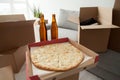 Pizza, beer and boxes, moving in celebration housewarming party Royalty Free Stock Photo