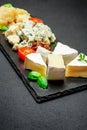 Cheese plate with Assorted cheeses Camembert, Brie, Parmesan blue cheese Royalty Free Stock Photo