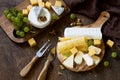 Cheese plate. Assortment of cheeses, grapes and nuts. Royalty Free Stock Photo
