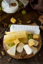 Cheese plate. Assortment of cheeses, grapes and nuts on dark rustic wooden table. Royalty Free Stock Photo