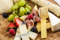 Cheese plate with bread grapes and strawberries