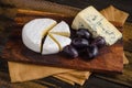 Cheese plate Camembert grapes on wooden table