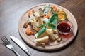 Cheese plate with cheeses Dorblu, Parmesan, Brie, Camembert and Roquefort in serving on the table from an old tree. Royalty Free Stock Photo