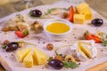 Cheese plate with cheeses Dorblu, Parmesan, Brie, Camembert and Roquefort in serving on the table from an old tree close Royalty Free Stock Photo