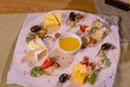 Cheese plate with cheeses Dorblu, Parmesan, Brie, Camembert and Roquefort in serving on the table from an old tree close Royalty Free Stock Photo