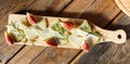 Cheese plate - cheeses and figs on wooden background Royalty Free Stock Photo