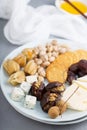 Cheese plate with crackers, dates and nuts Royalty Free Stock Photo