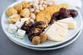 Cheese plate with crackers, dates and nuts Royalty Free Stock Photo