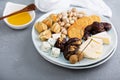 Cheese plate with crackers, dates and nuts Royalty Free Stock Photo