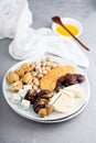 Cheese plate with crackers, dates and nuts Royalty Free Stock Photo