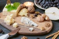Cheese plate from different kind of cheese - Emmental, Homemade, Parmesan, blue cheese, bread sticks, walnuts, raisin, pear,