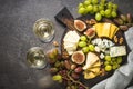 Cheese plate with grapes, figs and nuts.