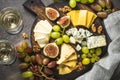 Cheese plate with grapes, figs and nuts. Royalty Free Stock Photo