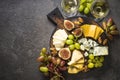 Cheese plate with grapes, figs and nuts.