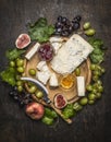 Cheese plate with gorgonzola and Camembert cheese with Knife for cheese white and dark grapes, honey and jam on a wooden cutting Royalty Free Stock Photo