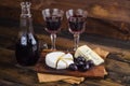 Cheese plate with grape and wine on wood Royalty Free Stock Photo